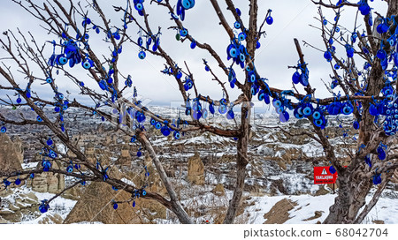 Blue Evil eye charms hang on the tree in Cappadocia, Turkey 68042704