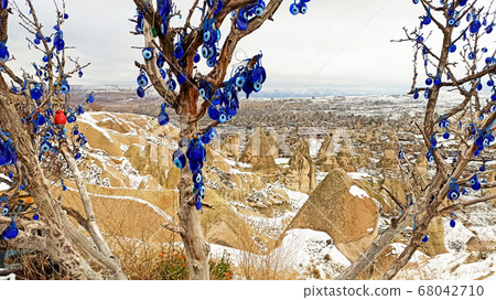 Blue Evil eye charms hang on the tree in Cappadocia, Turkey Blue Evil eye charms hang on the tree in Cappadocia, Turkey 68042710