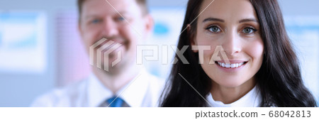 Happy man and woman office workers smiling at work 68042813