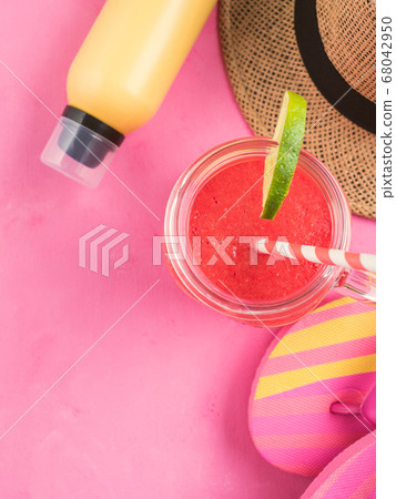 Straw hat, fli flops and red smoothie on pink 68042950