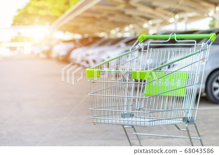 New supermarket trolley on the street and blur of 68043586