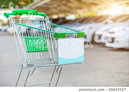 New supermarket trolley on the street and blur of 68043587