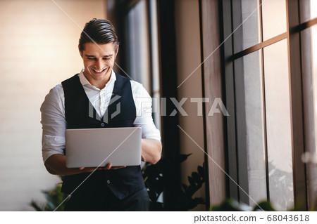 a Young Caucasian Businessman Working on Computer 68043618