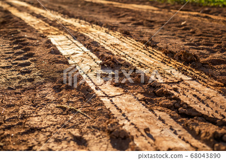 Wheel track on wet soil or mud 68043890