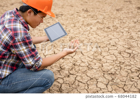 Young engineer working on site at the dam 68044182