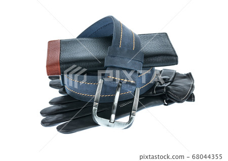Mens wallet, belt and gloves lying on top of each other Mens wallet, belt and gloves lying on top of each other 68044355