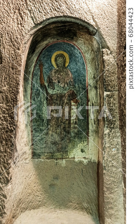 Gumusler Monastery from inside. Sacred Frescos on the wall of the Cave Church in Cappadocia Gumusler Monastery from inside. Sacred Frescos on the wall of the Cave Church in Cappadocia 68044423