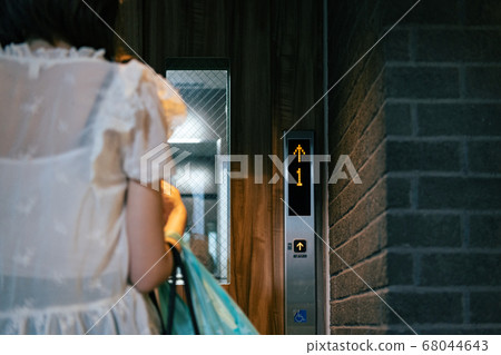 Woman using an elevator 68044643