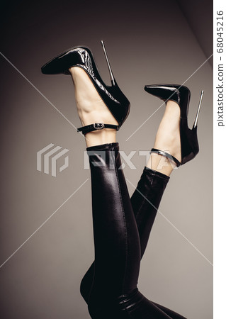 Slender female legs in spandex catsuit and a 68045216