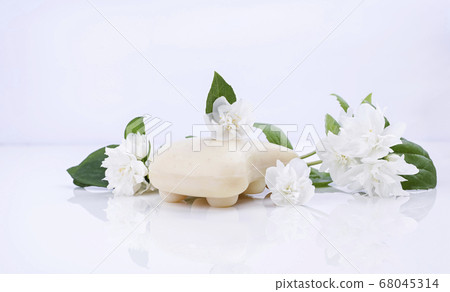 Handmade jasmine soap. Natural cosmetics for spa treatments and body care. Soap and fresh jasmine Handmade jasmine soap. Natural cosmetics for spa treatments and body care. Soap and fresh jasmine 68045314