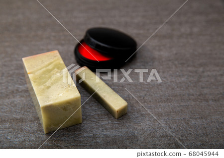 A stone carved seal with a sword. Stone carving and vermilion. A seal, seal, or signature to be stamped on a document. 68045944