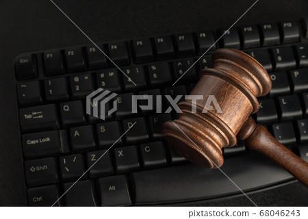 Wooden Judges gavel and keyboard. Close up. Legal Wooden Judges gavel and keyboard. Close up. Legal 68046243