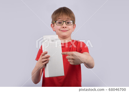Happy boy gives package of milk or juice. Copy 68046700