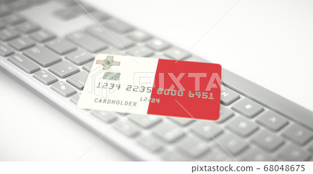 Plastic bank card depicting flag of Malta on computer keyboard. Fictional numbers Plastic bank card depicting flag of Malta on computer keyboard. Fictional numbers 68048675