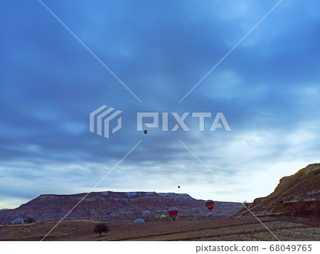 Colorful hot air balloons flying at the sunrise with rocky landscape in Cappadocia, Turkey Colorful hot air balloons flying at the sunrise with rocky landscape in Cappadocia, Turkey 68049765