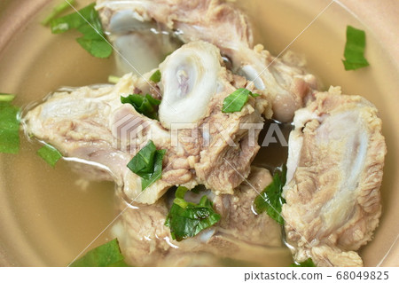 boiled pork bone with Chinese celery soup dipping spicy chili sauce boiled pork bone with Chinese celery soup dipping spicy chili sauce 68049825