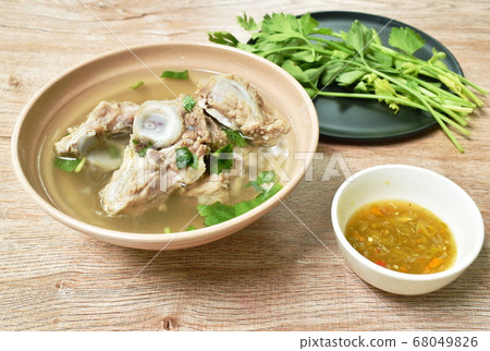 boiled pork bone with Chinese celery soup dipping spicy chili sauce boiled pork bone with Chinese celery soup dipping spicy chili sauce 68049826