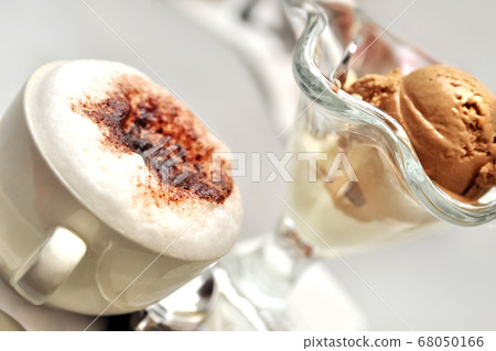 Cup of cappuccino with milk foam sprinkled with Cup of cappuccino with milk foam sprinkled with 68050166