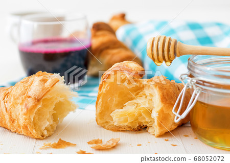 French style breakfast with croissants pastry, coffee and glass of honey. French style breakfast with croissants pastry, coffee and glass of honey. 68052072