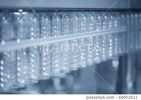 The PET bottles hanging  on the conveyor belt. 68052621