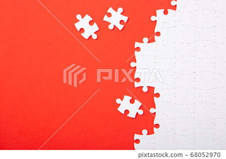 Blank white puzzle pieces on red background, flat 68052970