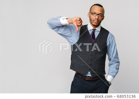 young black businessman with a dissenting serious dislike expression with thumbs down in disapproval young black businessman with a dissenting serious dislike expression with thumbs down in disapproval 68053136