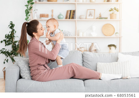 Mother-baby emotional attachment. Young Mom bonding with adorable toddler baby at home 68053561