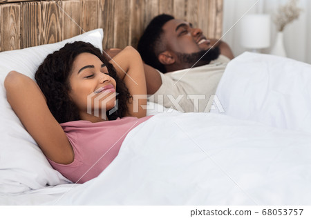 Relaxed african couple enjoying their new bed 68053757