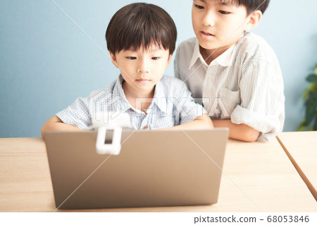A boy staring at a PC screen 68053846