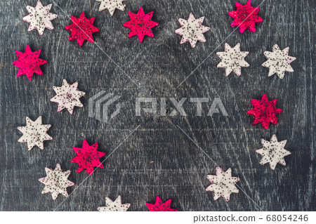 Pieces of sliced dragon fruit in the form of a star on an old withered background Pieces of sliced dragon fruit in the form of a star on an old withered background 68054246