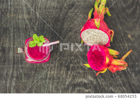 Smoothies of a red organic dragon fruit on an old wooden background Smoothies of a red organic dragon fruit on an old wooden background 68054255