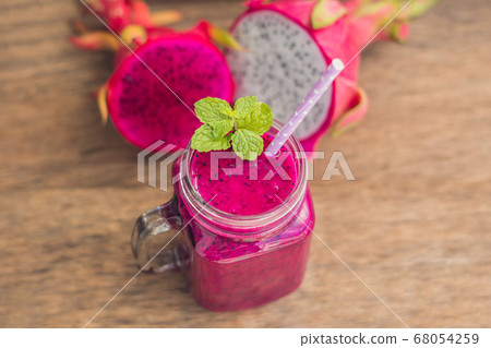 Smoothies of a red organic dragon fruit on an old wooden background 68054259