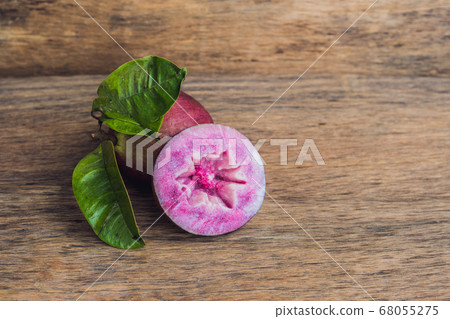 fresh Chrysophyllum cainito fruits on wood background fresh Chrysophyllum cainito fruits on wood background 68055275