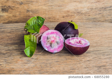 fresh Chrysophyllum cainito fruits on wood background fresh Chrysophyllum cainito fruits on wood background 68055280
