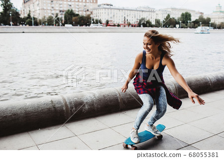 beautiful blonde skateboard on the promenade 68055381