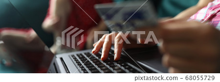 Female hand hold white plastic credit card closeup background 68055729