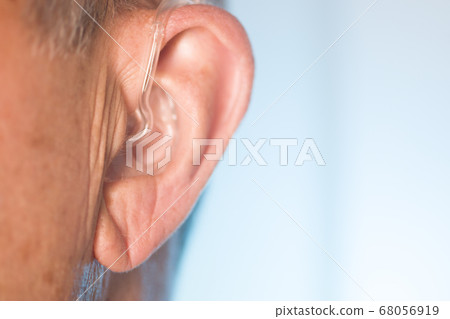 Man with hearing aid 68056919