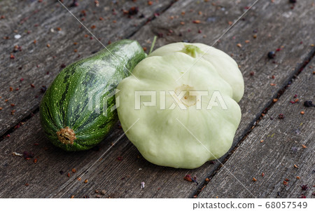 Zucchini and two pattypan squash harvested from the vegetable garden beds 68057549