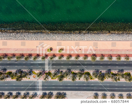 Coastal road with palm trees and running track in Coastal road with palm trees and running track in 68057844