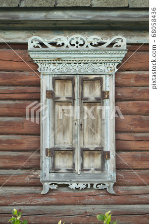 Old house vintage carved windows with wooden lacy shutters close up Old house vintage carved windows with wooden lacy shutters close up 68058436