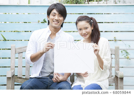 A couple with a message board A couple with a message board 68059844