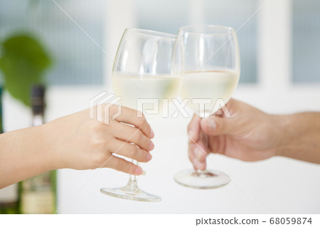 Couple toasting with white wine 68059874