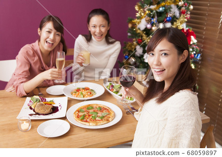 Woman having a Christmas party Woman having a Christmas party 68059897