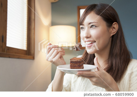 Woman eating chocolate cake Woman eating chocolate cake 68059900