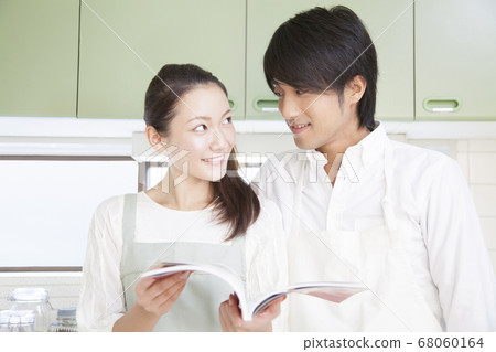 A couple looking at a recipe book A couple looking at a recipe book 68060164