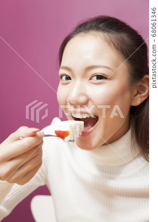 Woman eating cake Woman eating cake 68061346