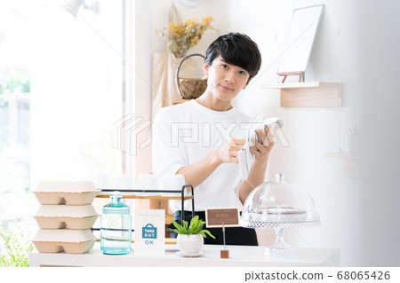 A man working as a cafe clerk [takeout] 68065426