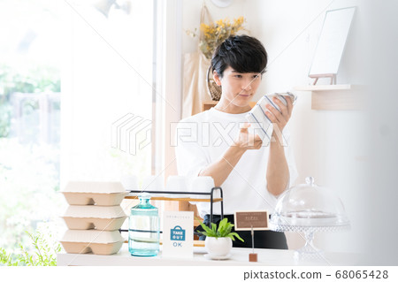 A man working as a cafe clerk [takeout] 68065428