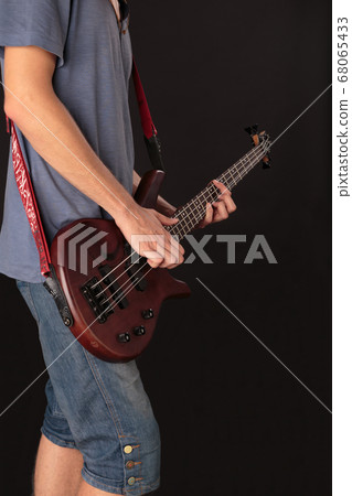 Rock musician is playing electrical guitar. 68065433