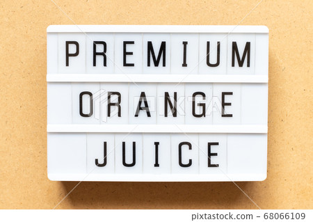 Lightbox with word premium orange juice on wood background Lightbox with word premium orange juice on wood background 68066109